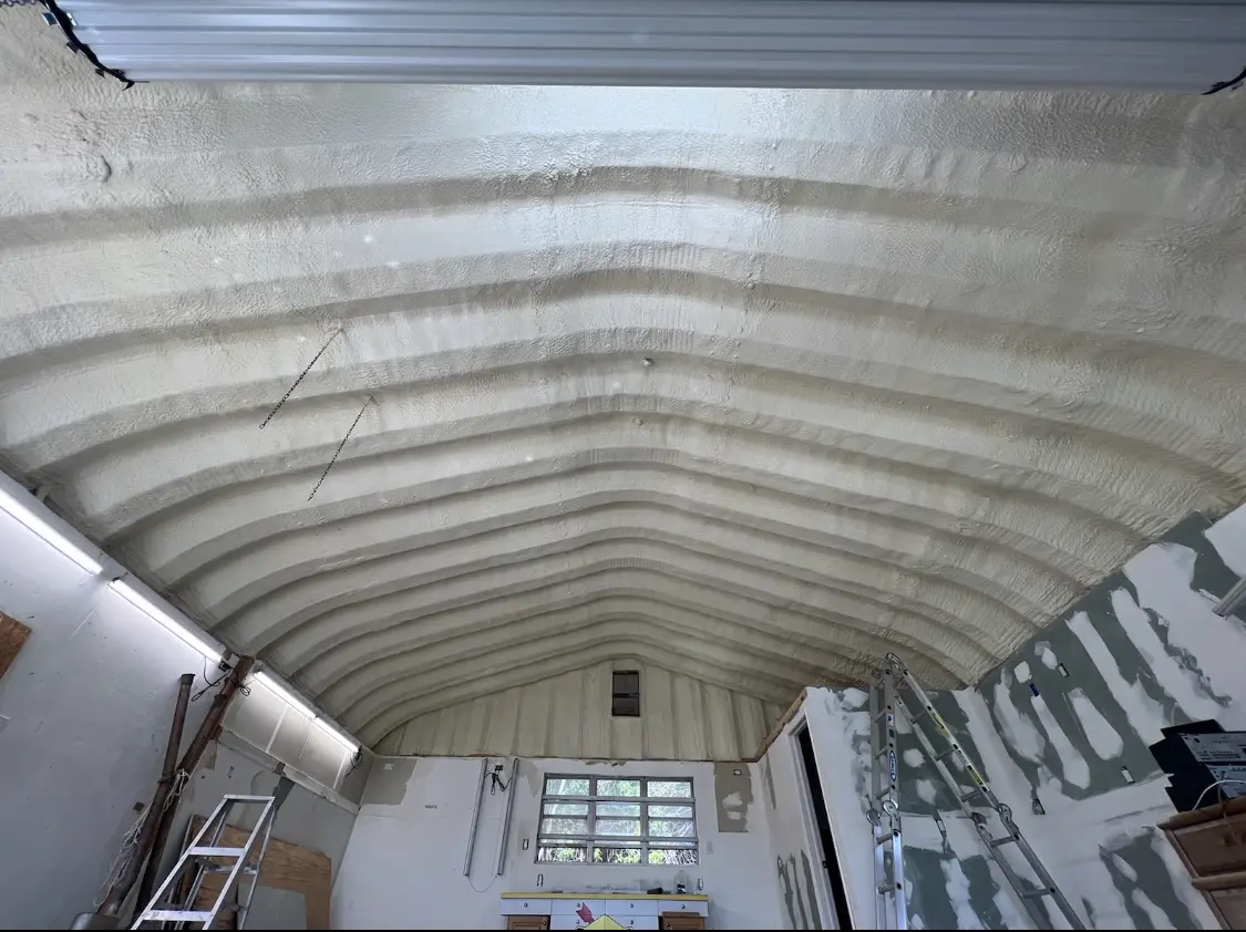 Spray polyurethane foam applied to the underside of a metal roof deck in Cairo